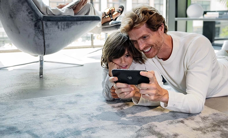 Father teaches his son how to control electric blinds on the app